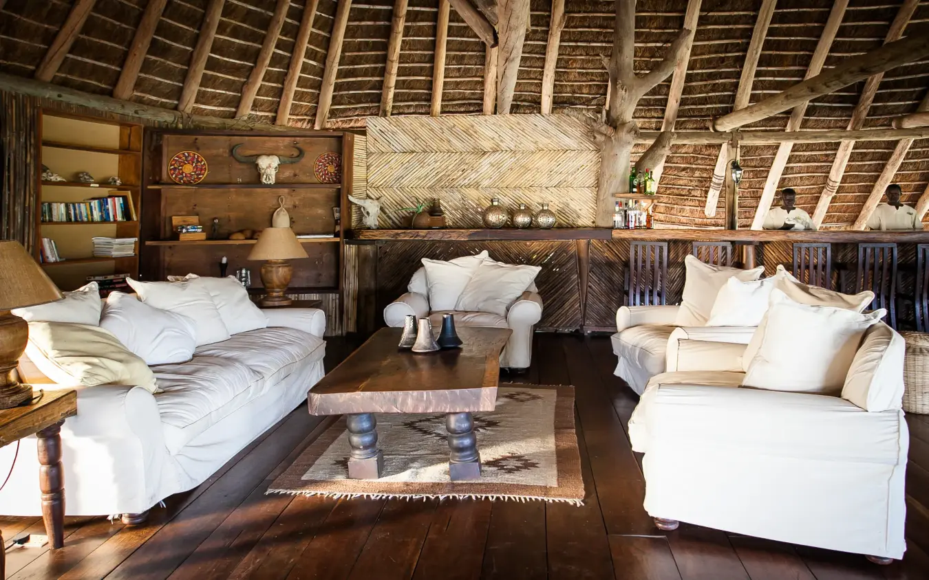 Spacious bedroom with white furnishings and thatched ceiling, Apoka Safari Lodge, Kidepo Valley, Uganda