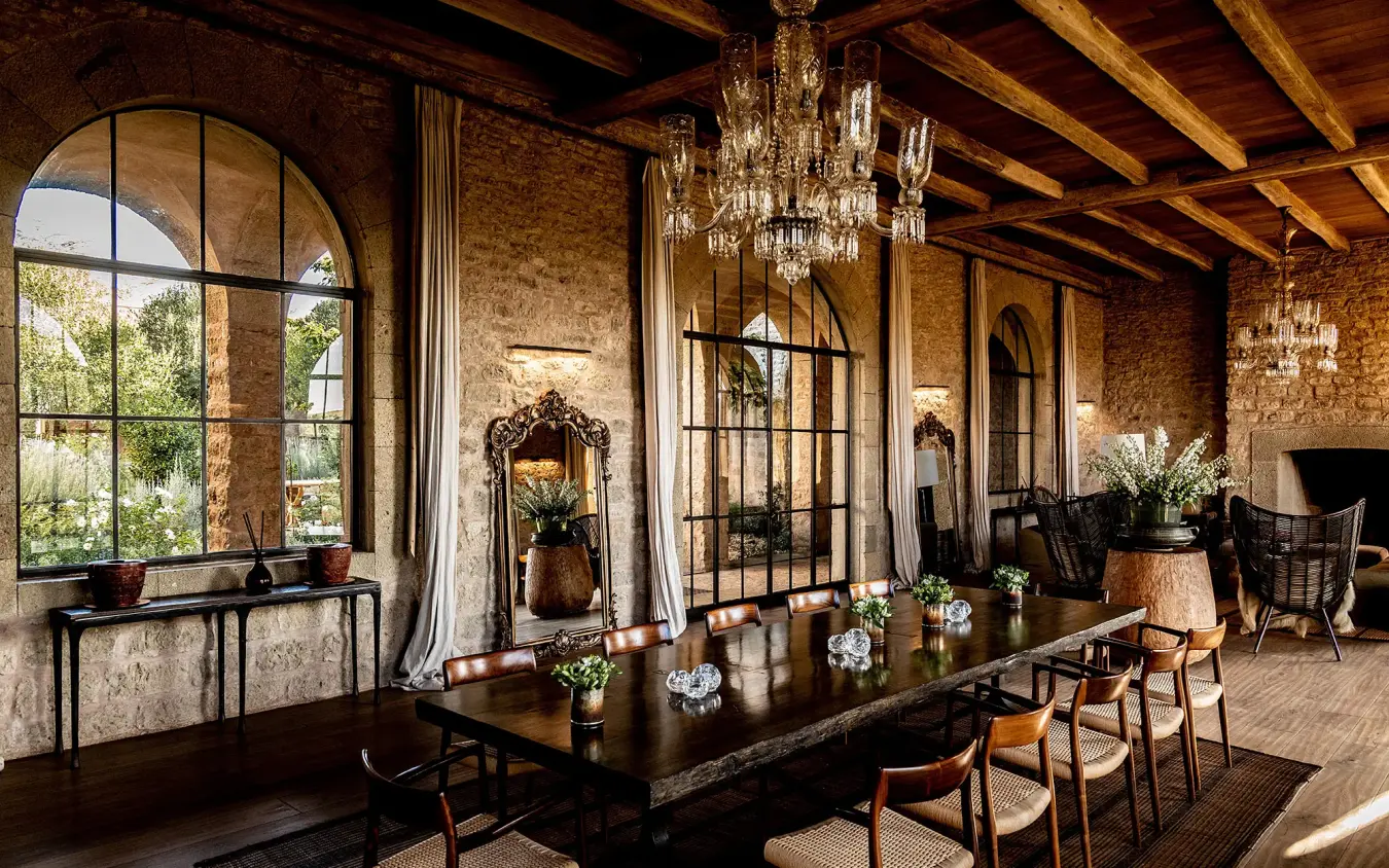 Elegant dining room with exposed brick and crystal chandeliers, Arijiju, Laikipia Highlands, Kenya