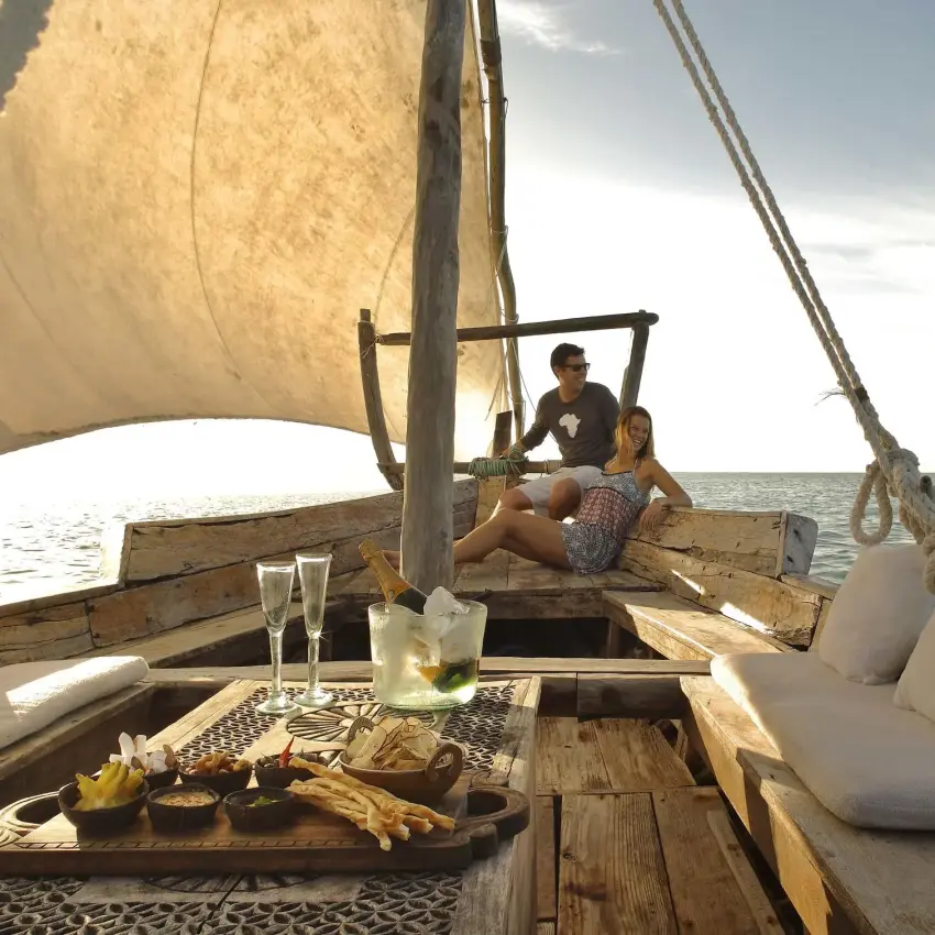 Guests sailing on traditional dhow boat at sea, Zanzibar & Pemba, Tanzania