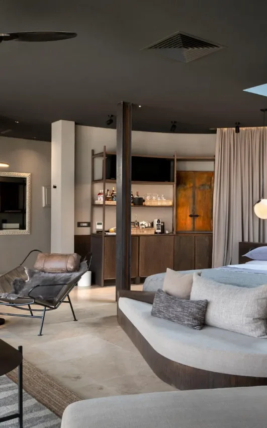 Spacious bedroom suite with lounge seating area and skylight, Sossusvlei Desert Lodge, NamibRand Private Reserve, Namibia
