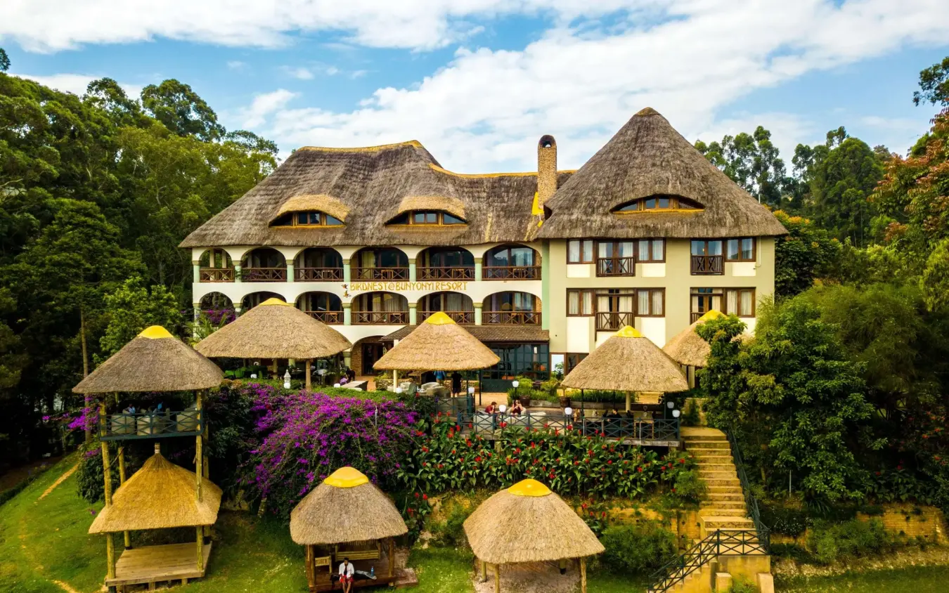 Thatched-roof lodge with cone structures and manicured gardens, Birdnest at Bunyonyi Resort, Lake Bunyonyi, Uganda