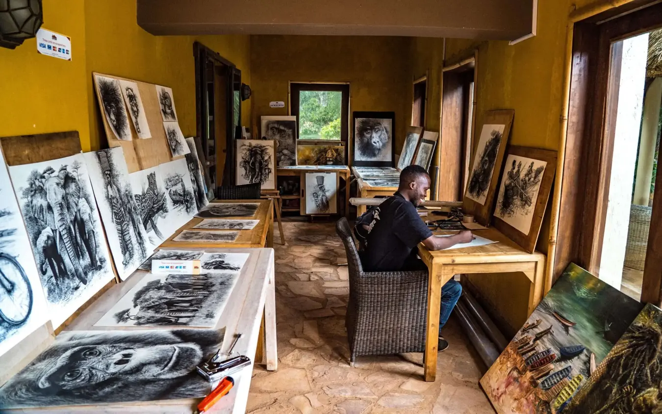 Artist studio with charcoal drawings and sketches displayed, Birdnest at Bunyonyi Resort, Lake Bunyonyi, Uganda