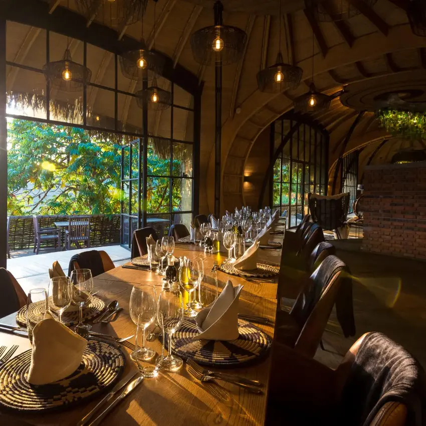 Fine dining room with set table and panoramic windows, Bisate Lodge, Volcanoes National Park, Rwanda