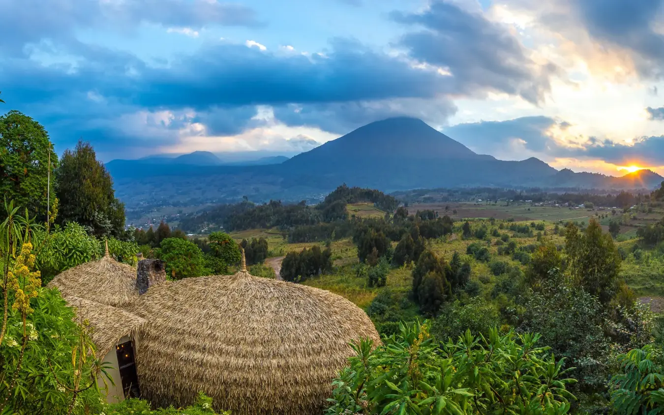 Mountain vista with traditional thatched structures and valley views, Bisate Lodge, Volcanoes National Park, Rwanda