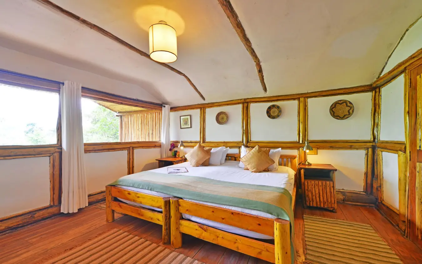 Wooden bedroom with double bed and large windows, Buhoma Lodge, Bwindi Impenetrable Forest, Uganda