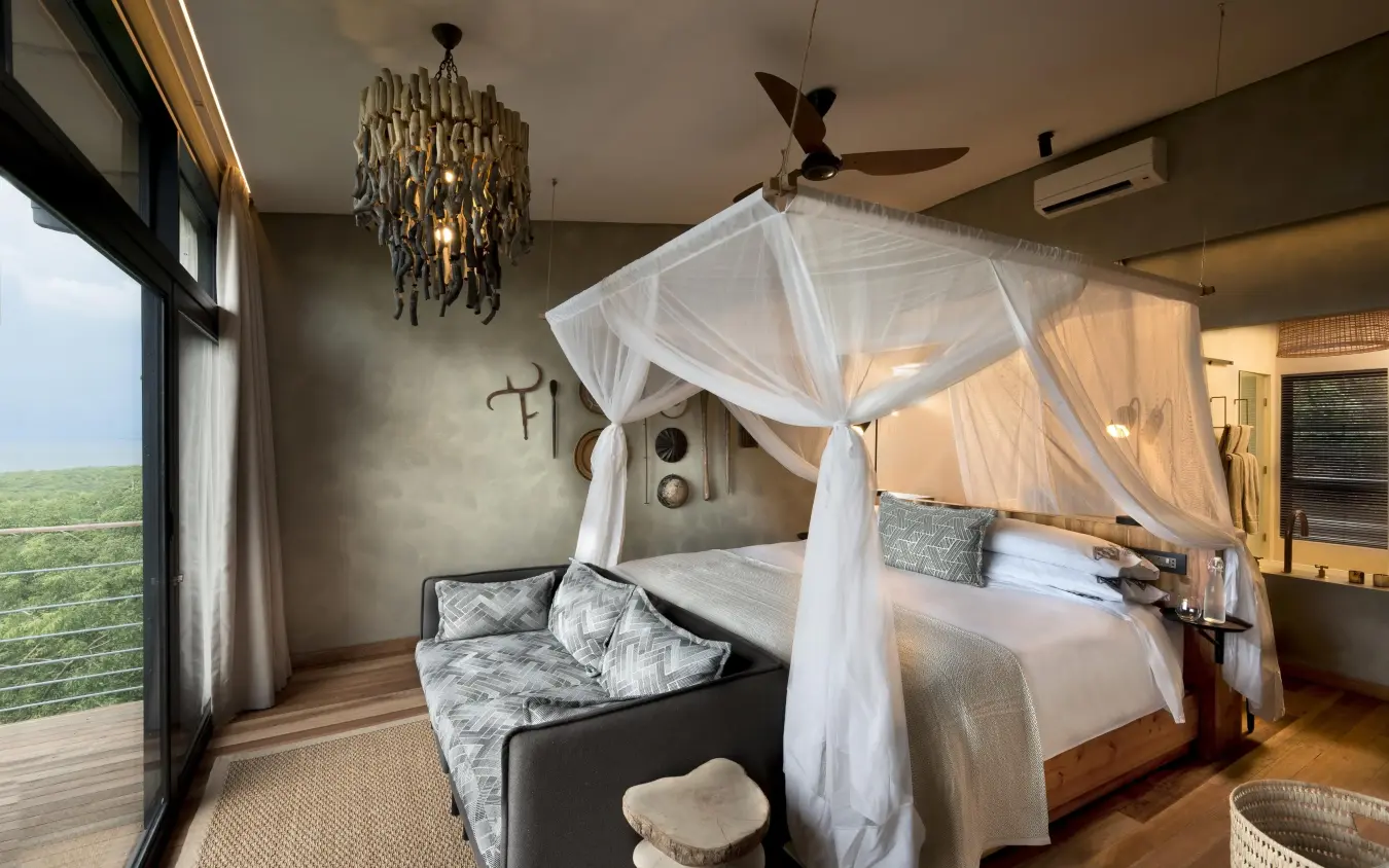 Luxury bedroom with canopy bed and panoramic views, Bumi Hills Safari Lodge, Matusadona National Park, Zimbabwe