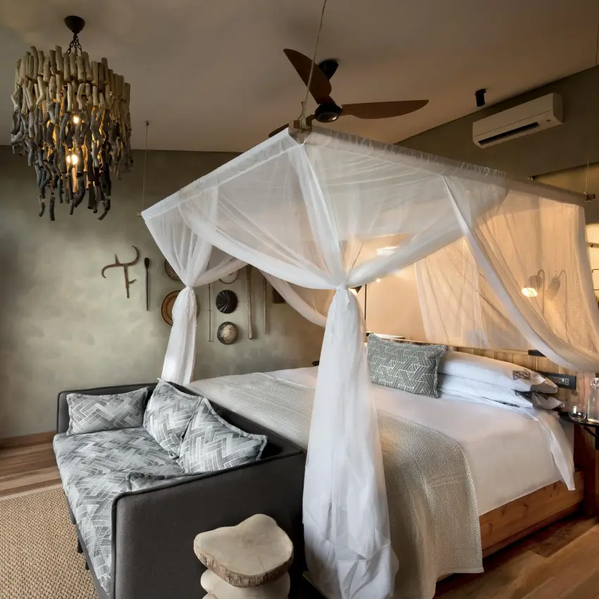 Luxury bedroom with canopy bed and panoramic views, Bumi Hills Safari Lodge, Matusadona National Park, Zimbabwe