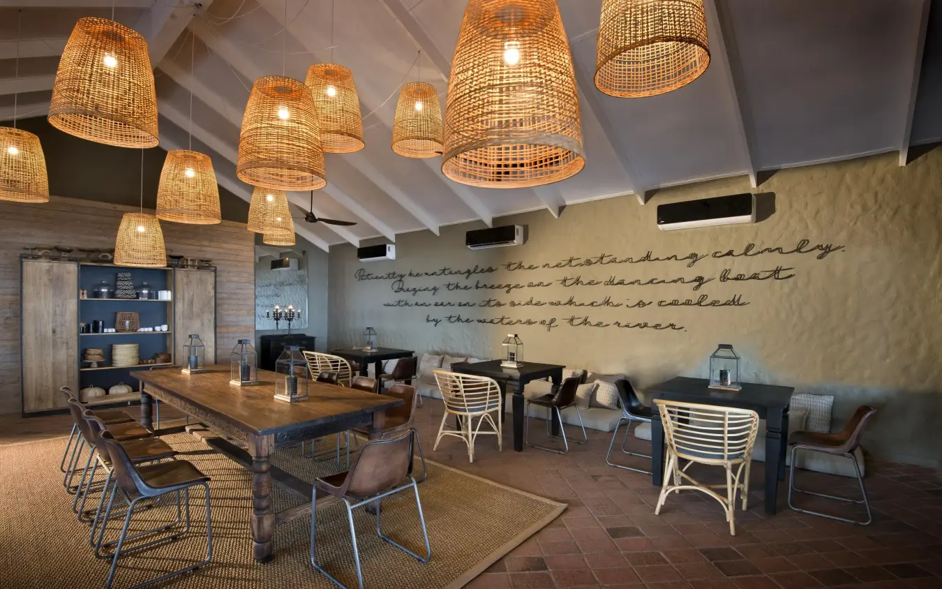 Open-plan dining and lounge area with woven pendant lights, Bumi Hills Safari Lodge, Matusadona National Park, Zimbabwe