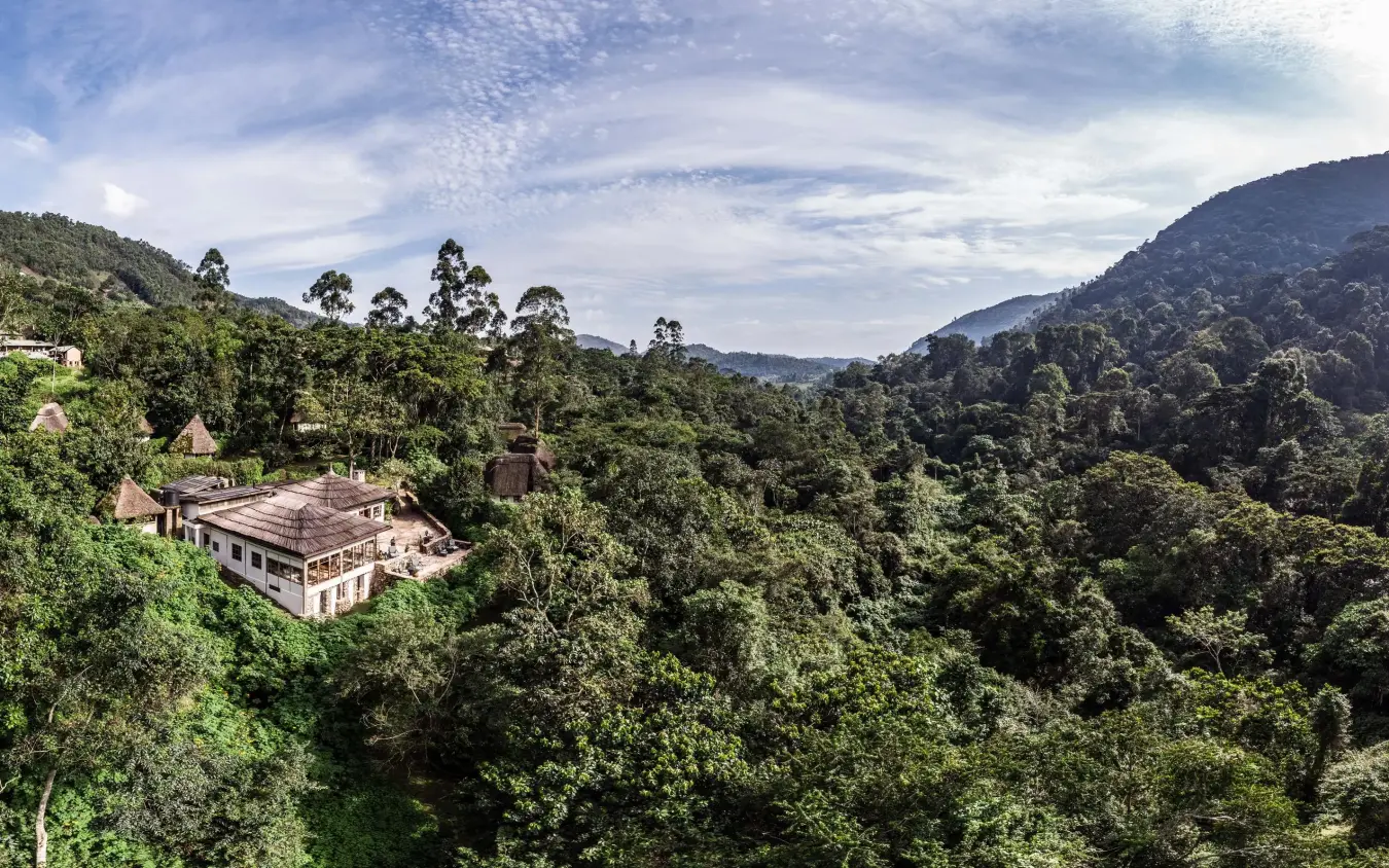 Lodge nestled in forested valley surrounded by green mountains, Bwindi Lodge, Bwindi Impenetrable Forest, Uganda