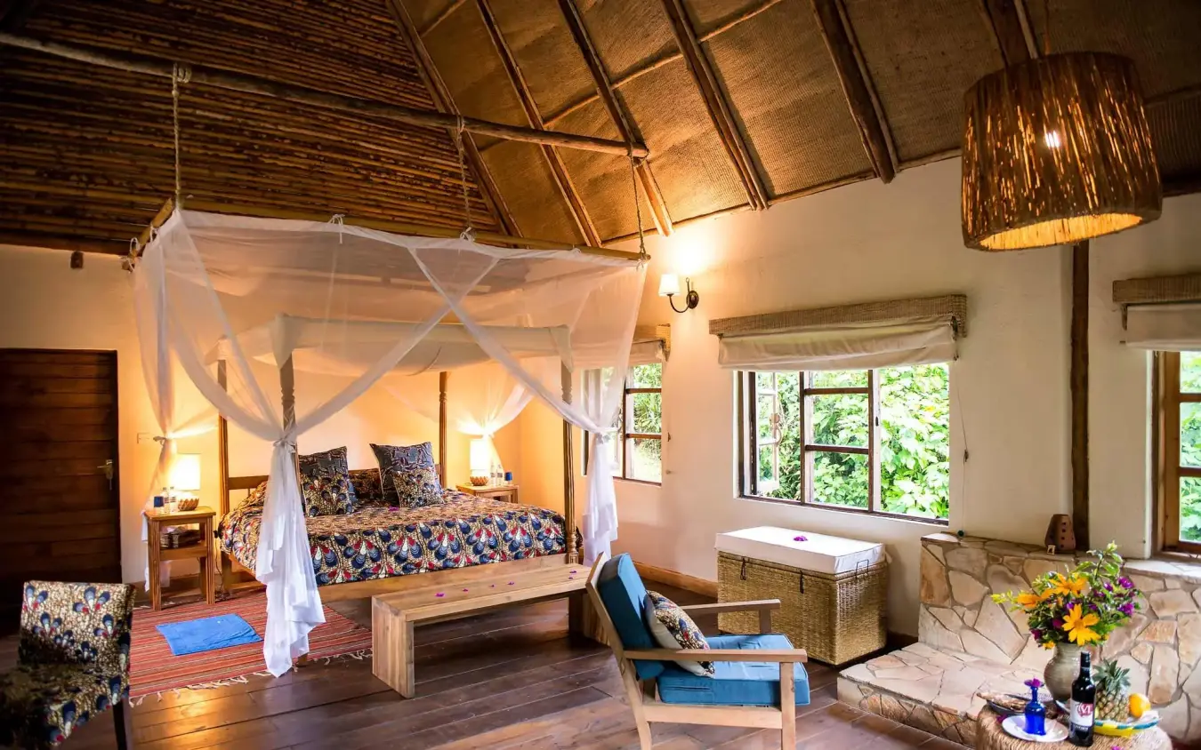 Spacious bedroom with canopy bed and high thatched ceiling, Bwindi Lodge, Bwindi Impenetrable Forest, Uganda
