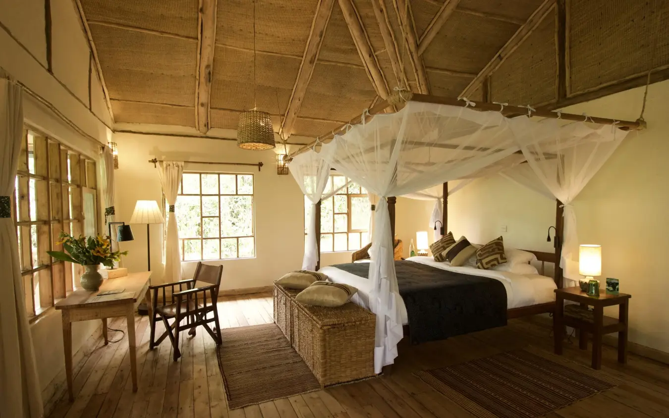 Spacious bedroom with four-poster canopy bed and desk, Bwindi Lodge, Bwindi Impenetrable Forest, Uganda