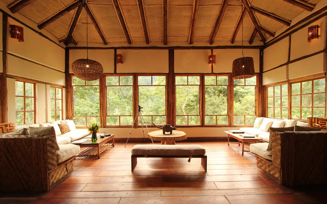 Spacious lounge with floor-to-ceiling windows overlooking forest, Bwindi Lodge, Bwindi Impenetrable Forest, Uganda
