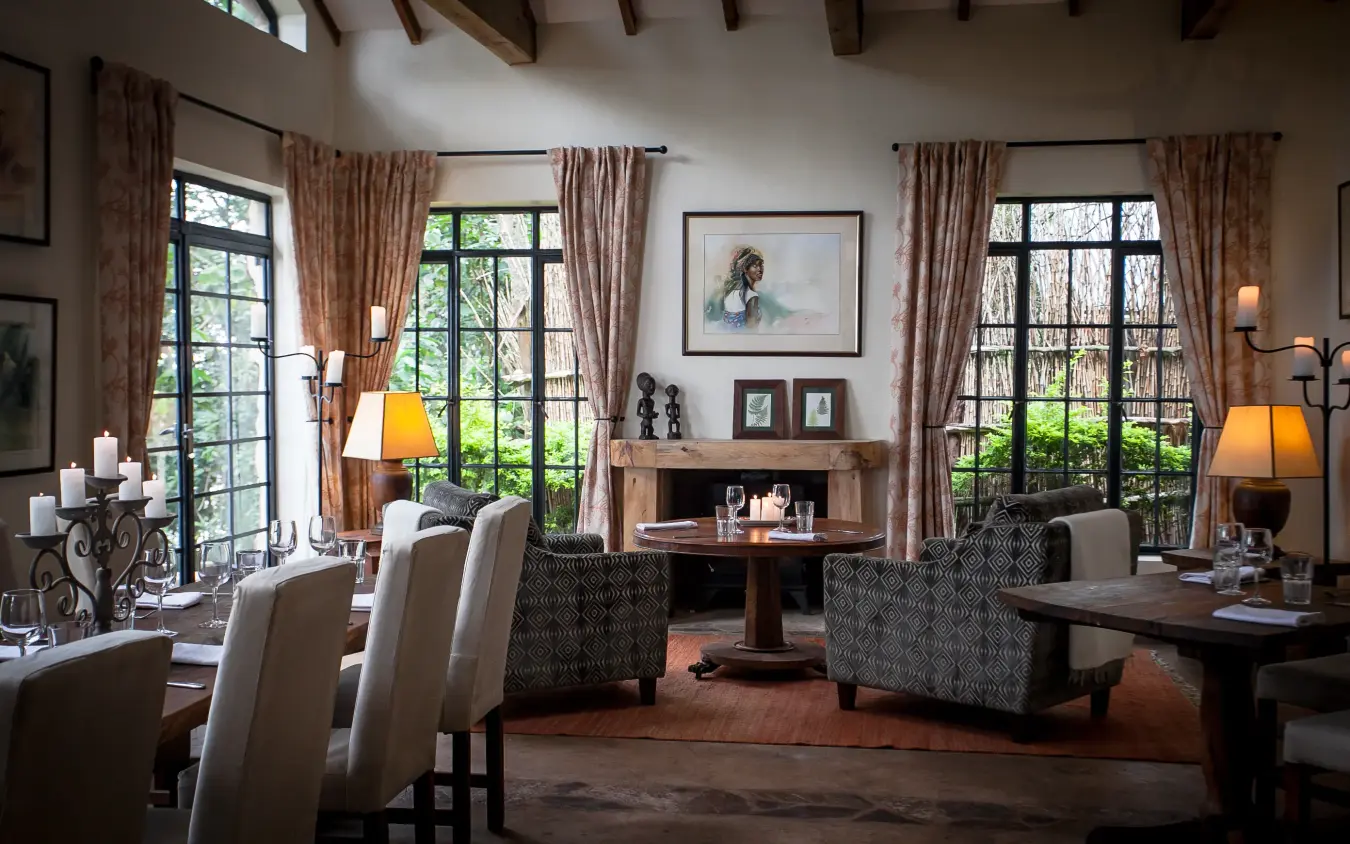 Spacious interior lounge with fireplace and garden views, Clouds Mountain Gorilla Lodge, Bwindi Impenetrable Forest, Uganda