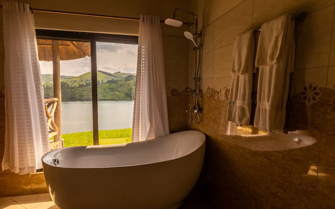 Freestanding bathtub with lake and landscape views, Crater Safari Lodge, Kibale Forest, Uganda
