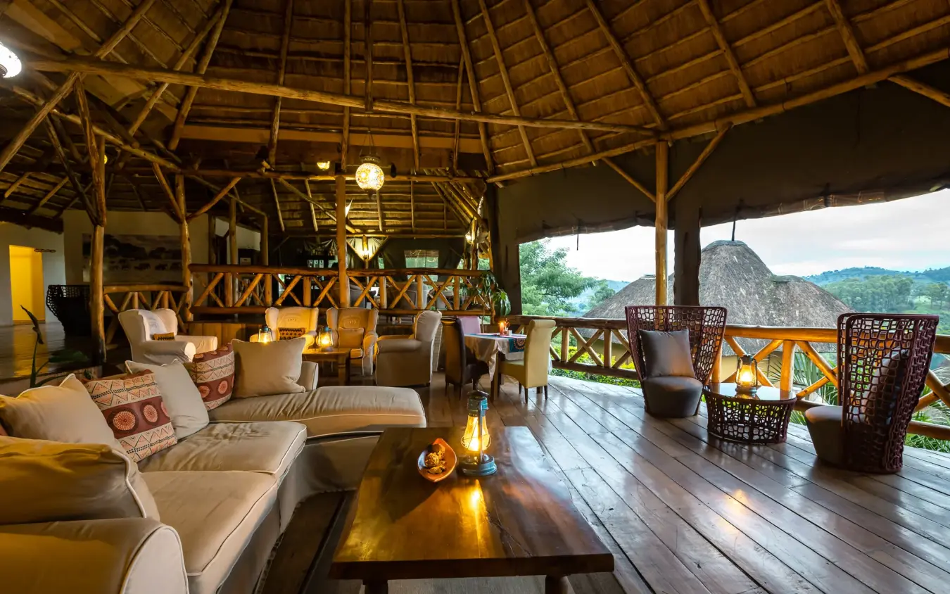 Open-air lounge with wooden beams overlooking forested mountains, Crater Safari Lodge, Kibale Forest, Uganda