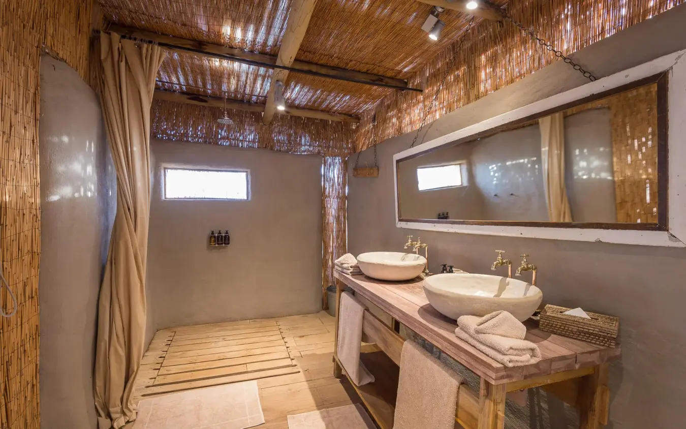 Luxury bathroom with double vessel sinks and natural materials, Damaraland Camp, Damaraland, Namibia