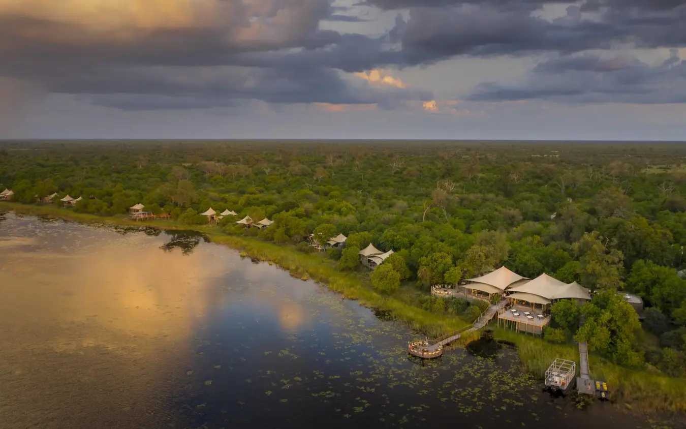 Aerial view of riverside lodge nestled in dense forest landscape, DumaTau, Linyanti Wildlife Reserve, Botswana