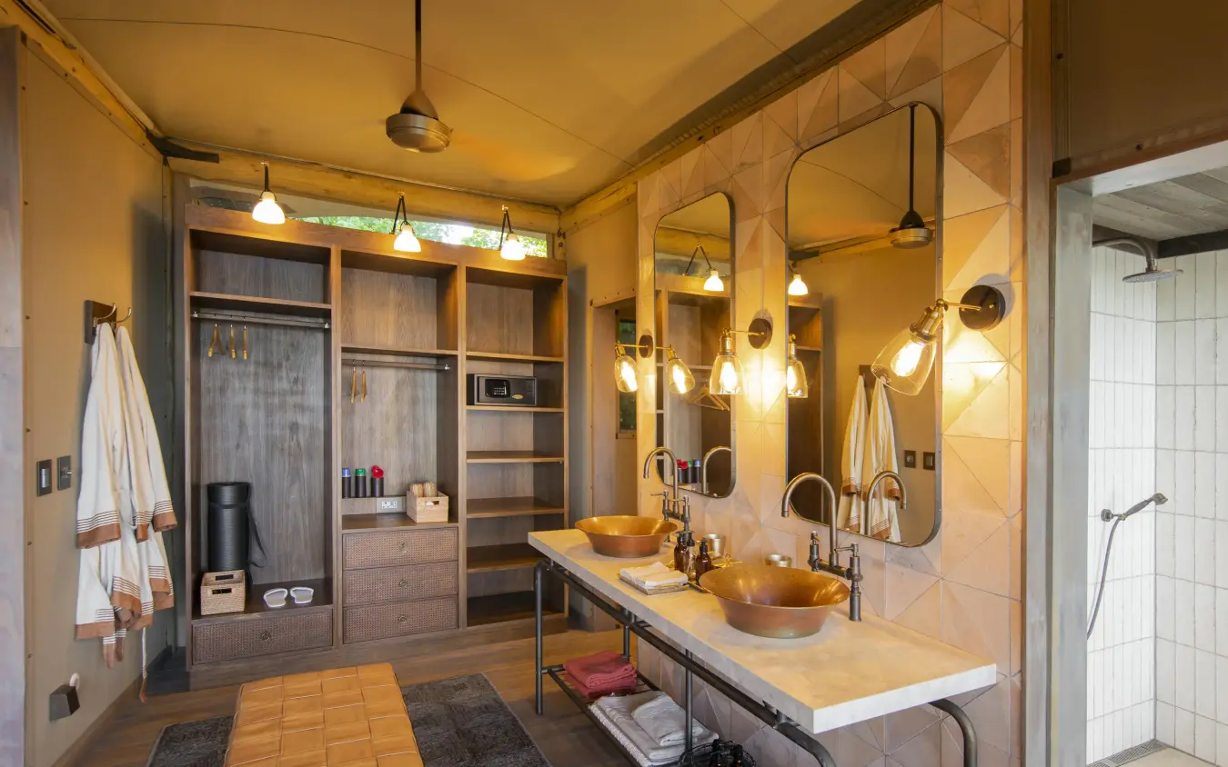 Luxury bathroom with dual sinks and walk-in closet area, DumaTau, Linyanti Wildlife Reserve, Botswana