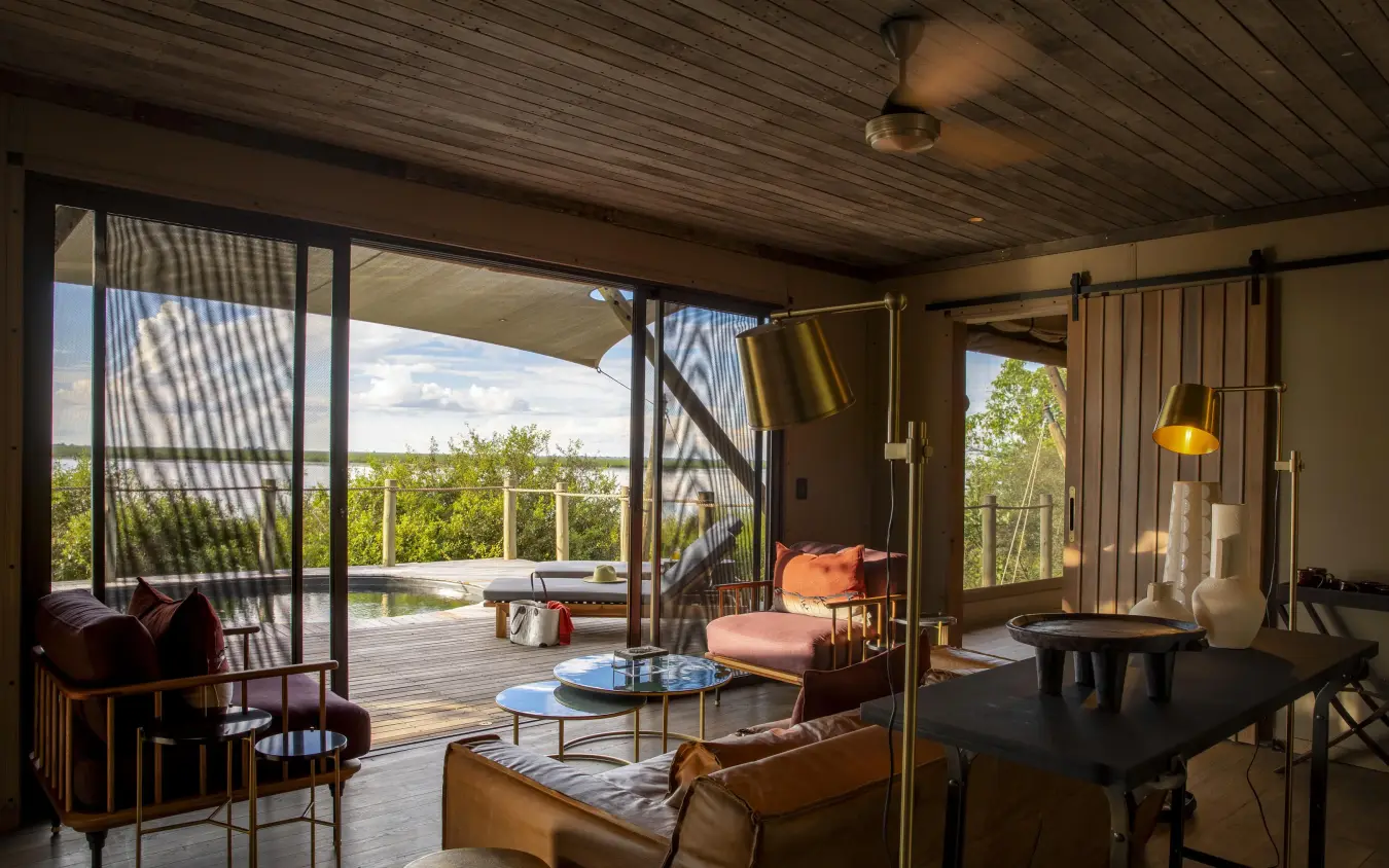 Open-plan lounge with deck and landscape views, DumaTau, Linyanti Wildlife Reserve, Botswana