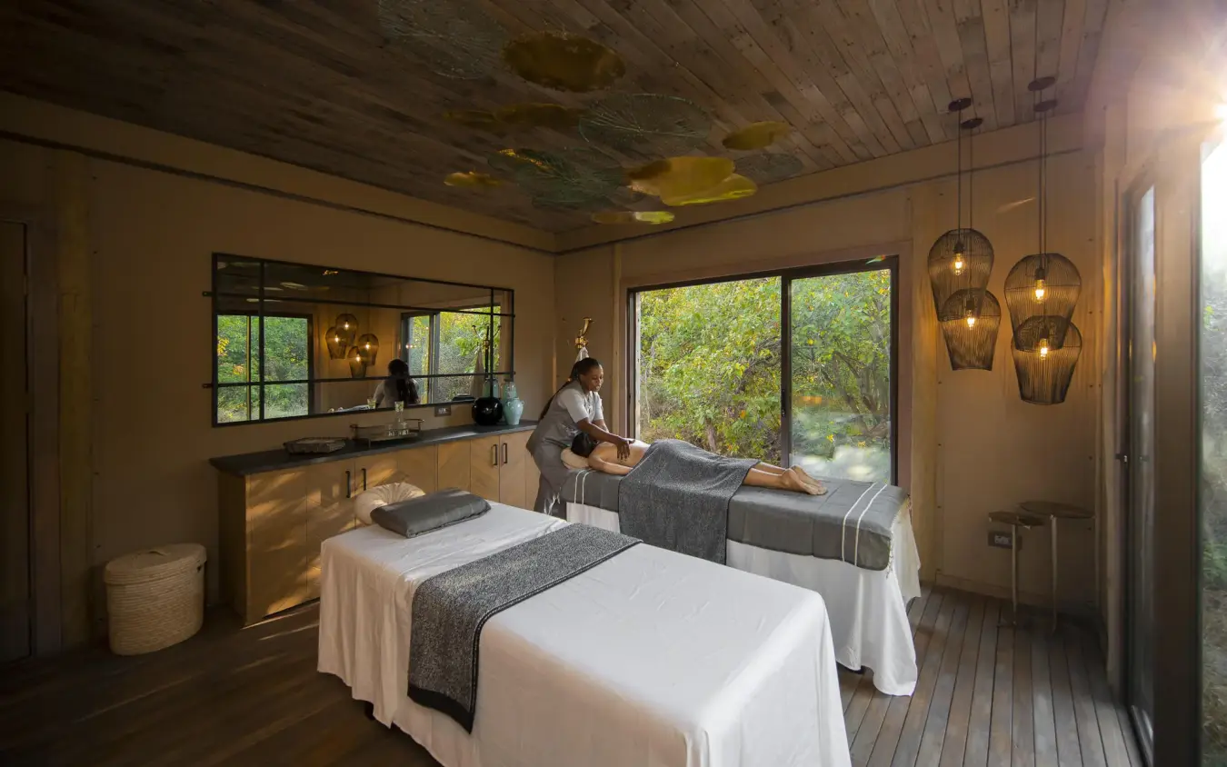 Spa treatment room with massage tables and forest views, DumaTau, Linyanti Wildlife Reserve, Botswana