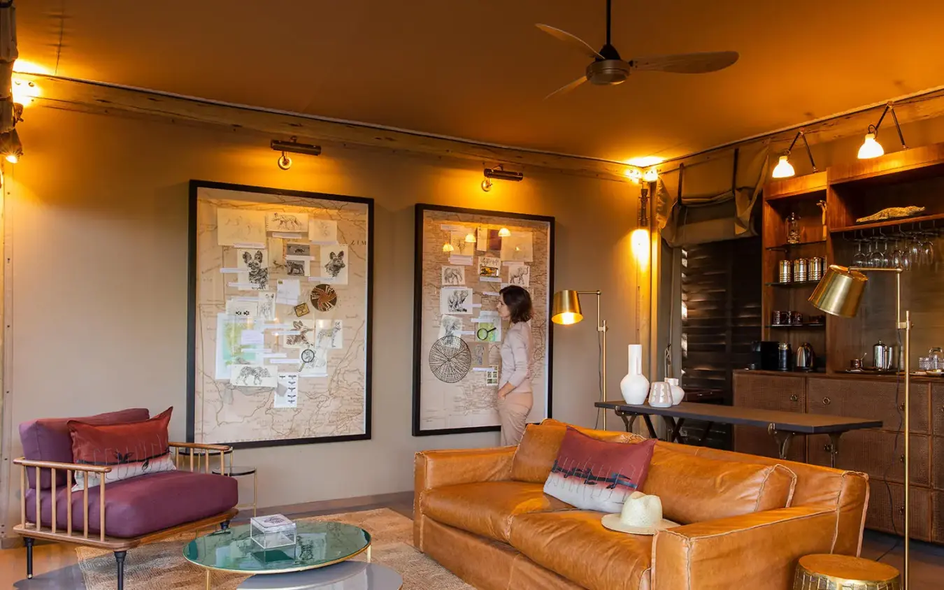 Modern lounge with leather sofa and framed artwork, DumaTau, Linyanti Wildlife Reserve, Botswana