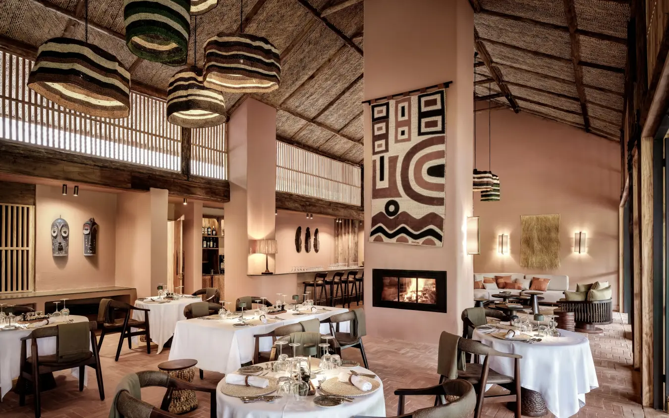 Fine dining restaurant interior with fireplace and pendant lighting, Gorilla Forest Lodge, Bwindi Impenetrable Forest, Uganda