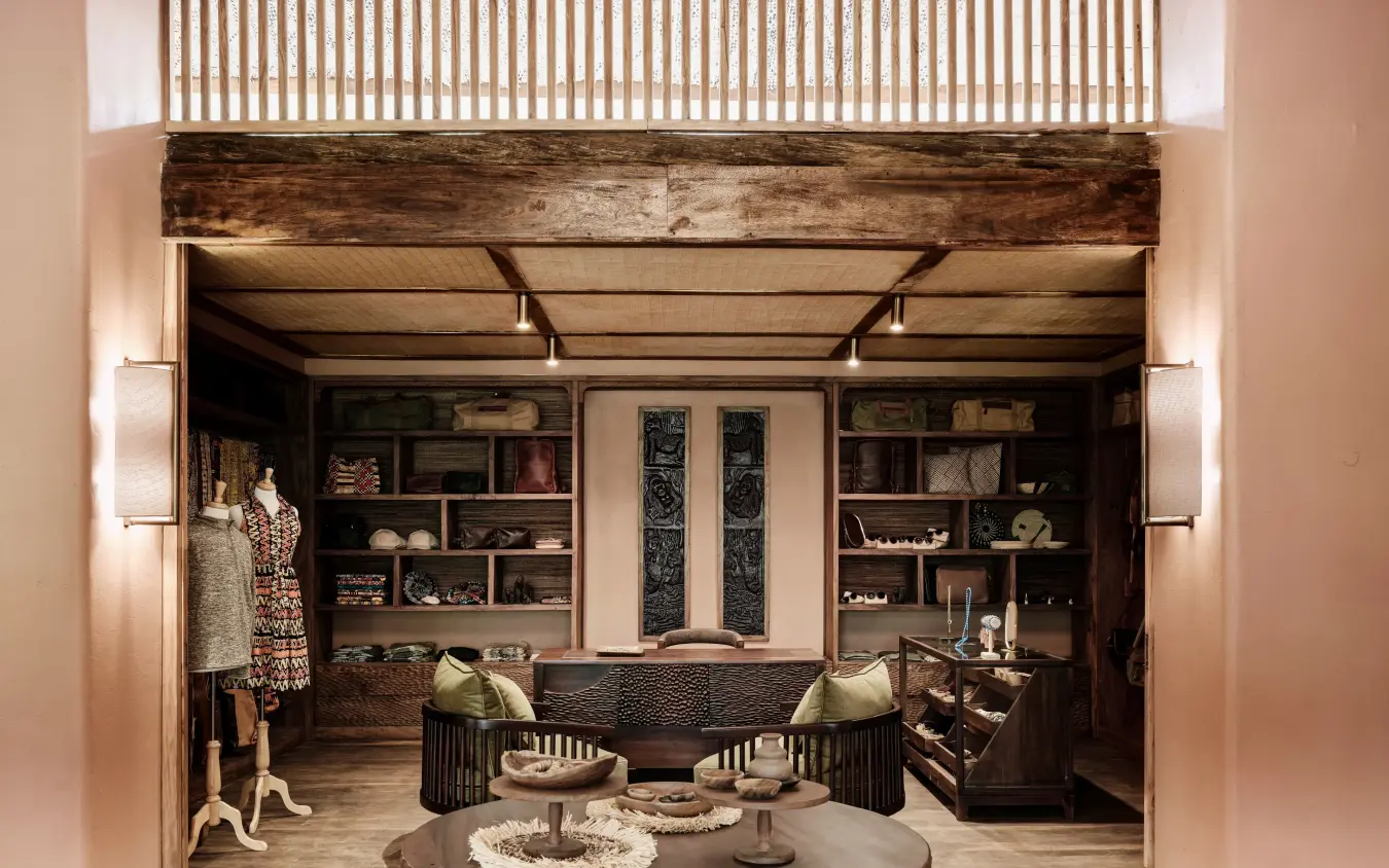 Open-plan lounge with seating, shelving, and central round table, Gorilla Forest Lodge, Bwindi Impenetrable Forest, Uganda