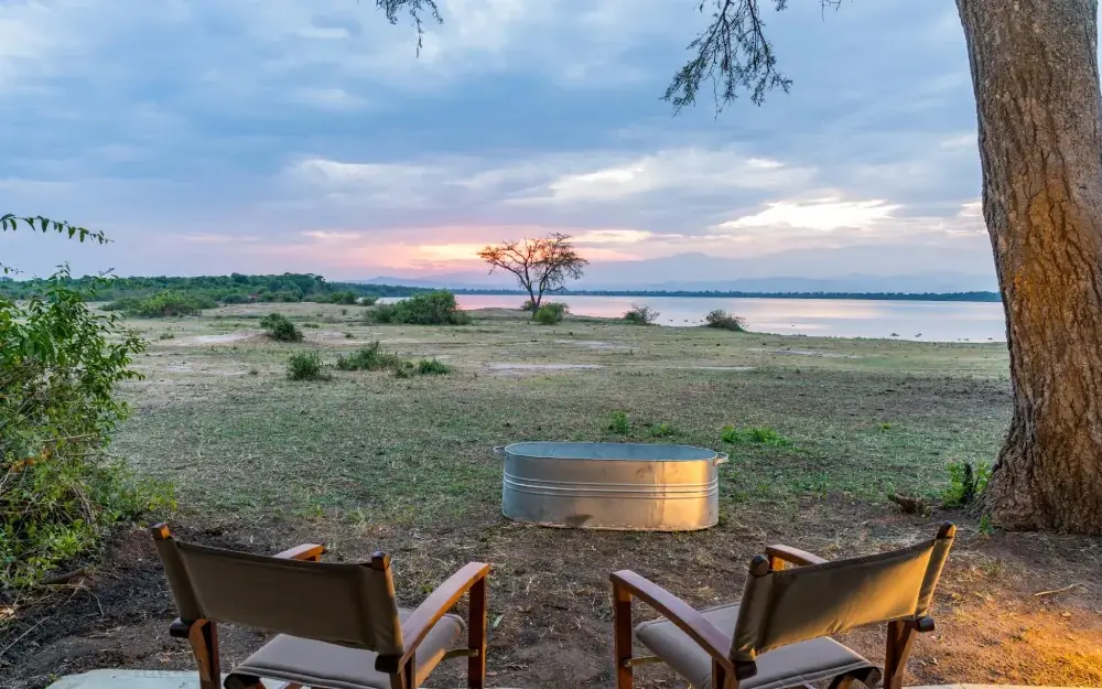 Sunset view from camp chairs overlooking lake, Honey Bear Bush Camp, Queen Elizabeth NP, Uganda