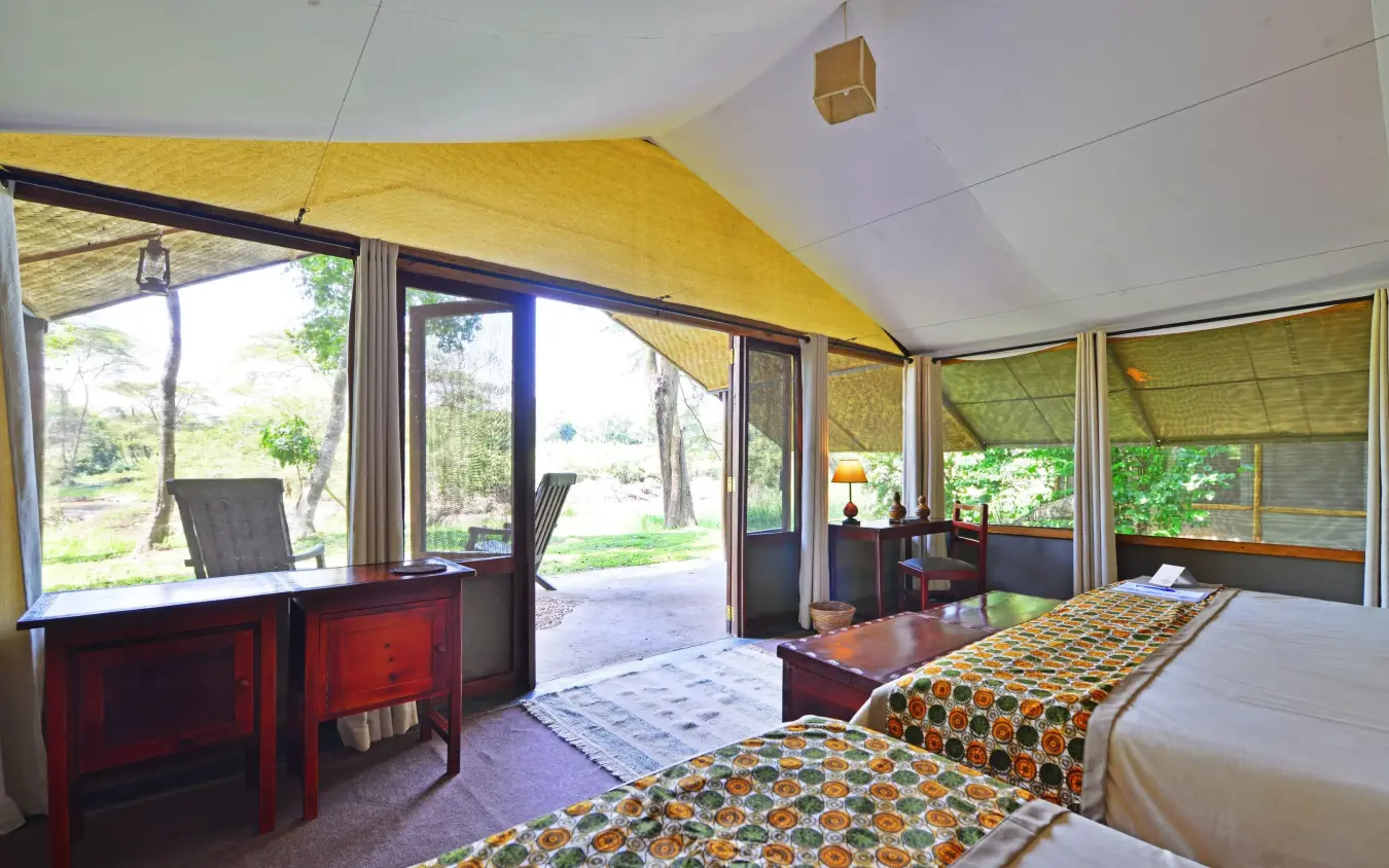 Spacious bedroom with twin beds and panoramic windows overlooking grounds, Ishasha Wilderness Camp, Queen Elizabeth NP, Uganda