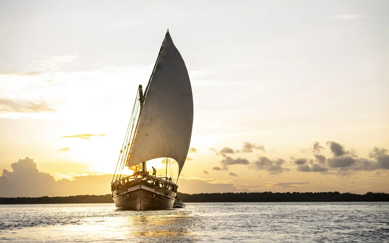 Traditional wooden dhow with sail on calm water at sunset, Tusitiri Dhow, Lamu Archipelago, Kenya