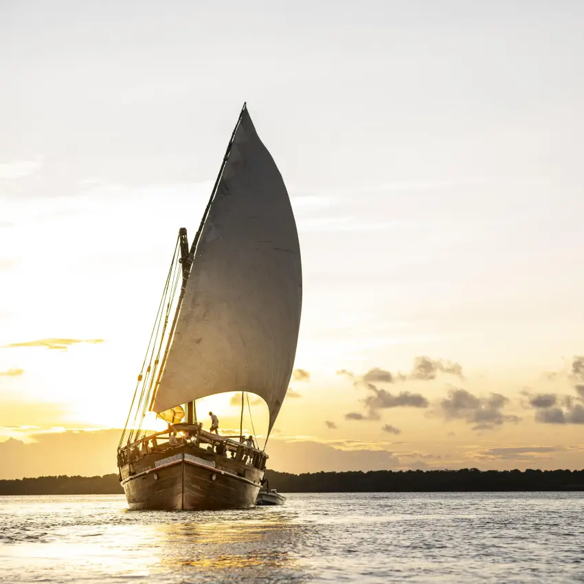 Traditional wooden dhow with sail on calm water at sunset, Tusitiri Dhow, Lamu Archipelago, Kenya
