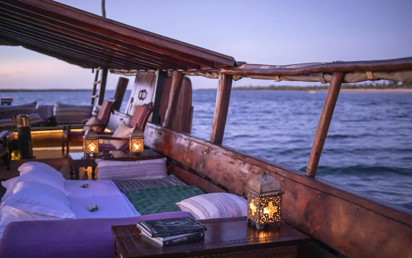 Wooden dhow deck at sunset overlooking calm ocean waters, Tusitiri Dhow, Lamu Archipelago, Kenya