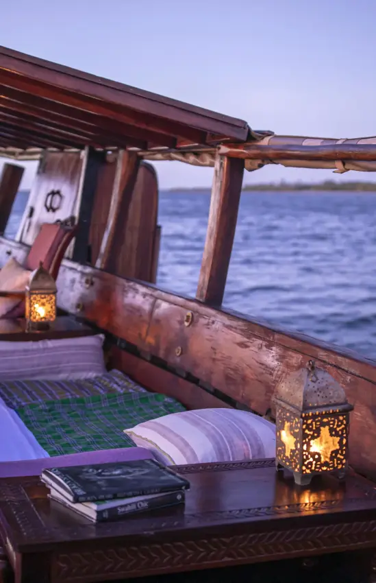 Wooden dhow deck at sunset overlooking calm ocean waters, Tusitiri Dhow, Lamu Archipelago, Kenya