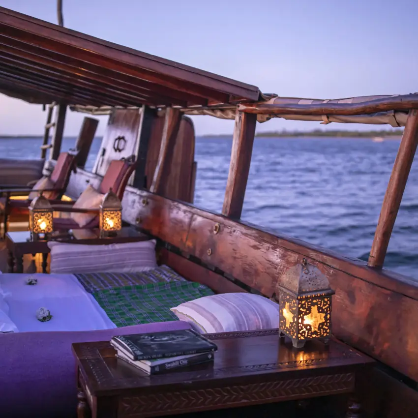 Wooden dhow deck at sunset overlooking calm ocean waters, Tusitiri Dhow, Lamu Archipelago, Kenya