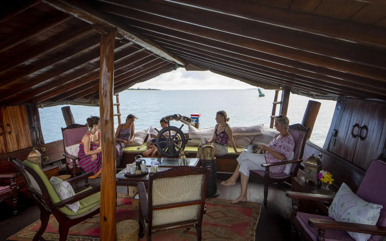 Guests relaxing on traditional dhow with water views, Tusitiri Dhow, Lamu Archipelago, Kenya