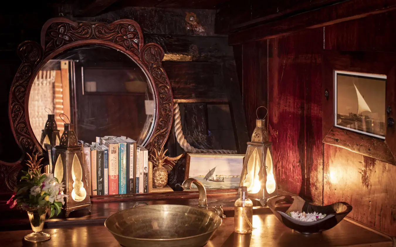 Ornate mirror and brass basin on wooden vanity table, Tusitiri Dhow, Lamu Archipelago, Kenya