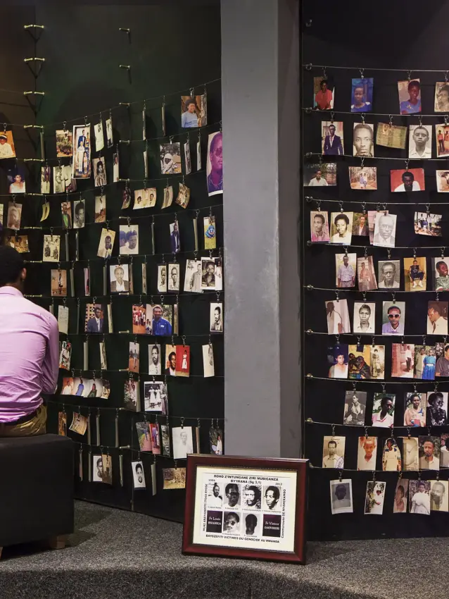 Visitor viewing wall of historical photographs in gallery space, Kigali Serena Hotel, Kigali, Rwanda
