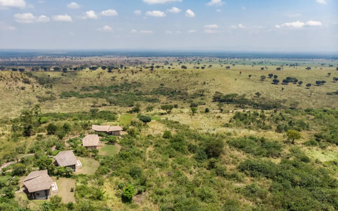 Aerial view of lodge bungalows scattered across savanna landscape, Kyambura Gorge Lodge, Queen Elizabeth NP, Uganda