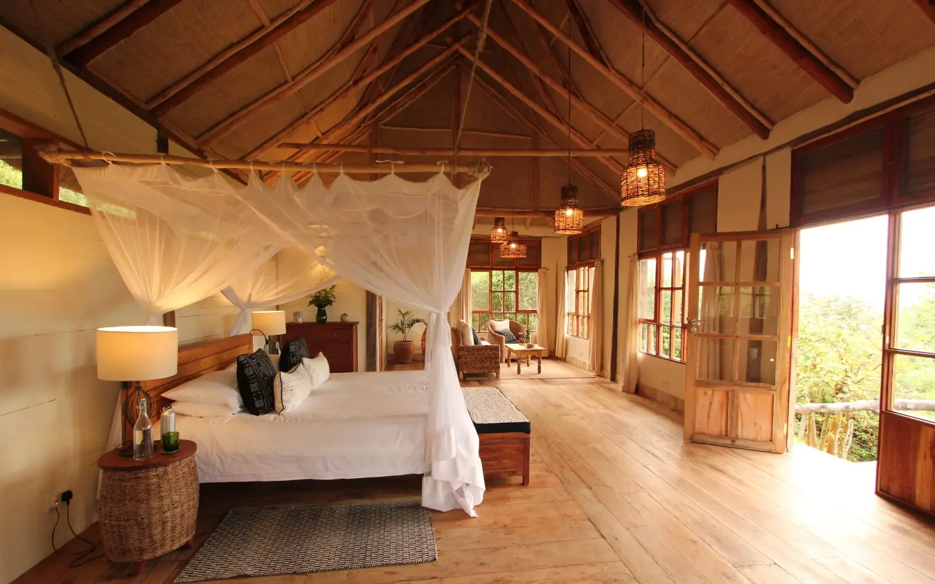 Spacious bedroom with canopy bed and wooden beams, Kyambura Gorge Lodge, Queen Elizabeth NP, Uganda