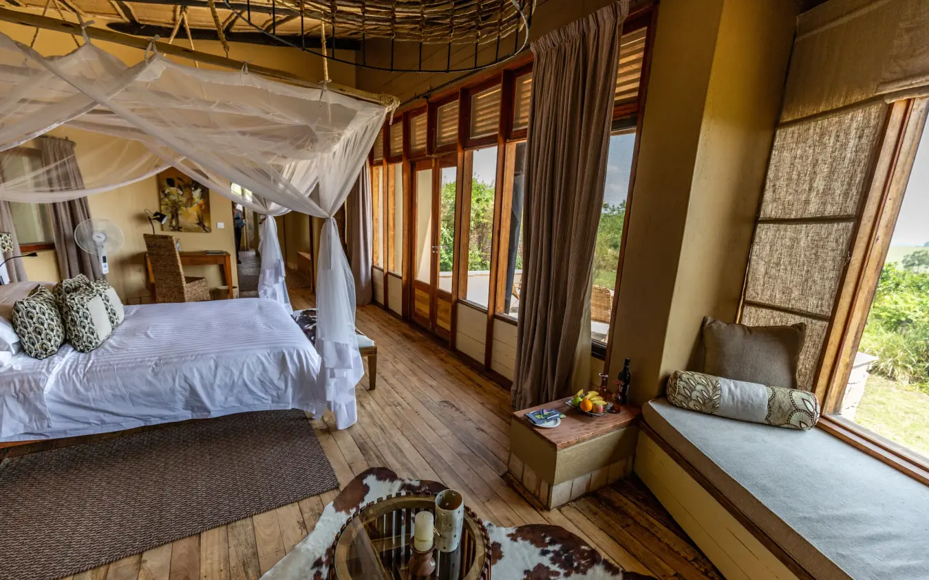 Spacious bedroom with canopy bed and panoramic windows, Kyambura Gorge Lodge, Queen Elizabeth NP, Uganda