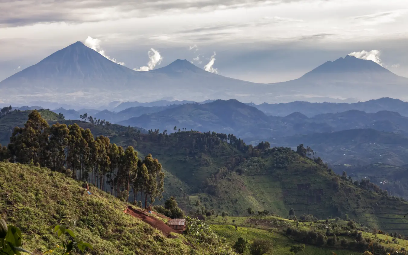 Volcanic peaks rising above forested valleys and terraced farmland