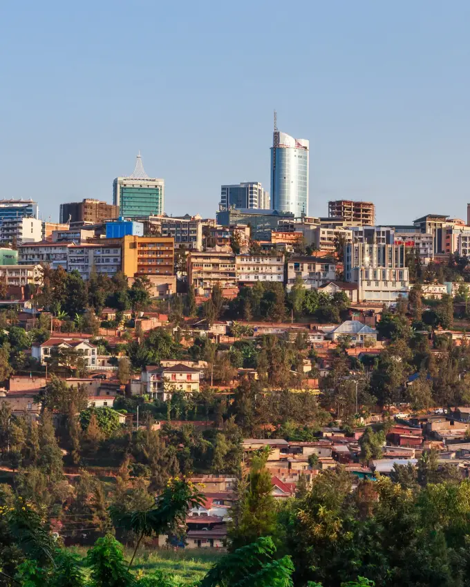 Hillside cityscape with buildings and green vegetation