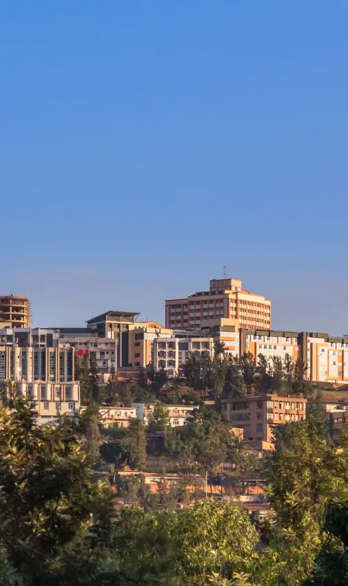 Urban cityscape with buildings on hillside at sunset