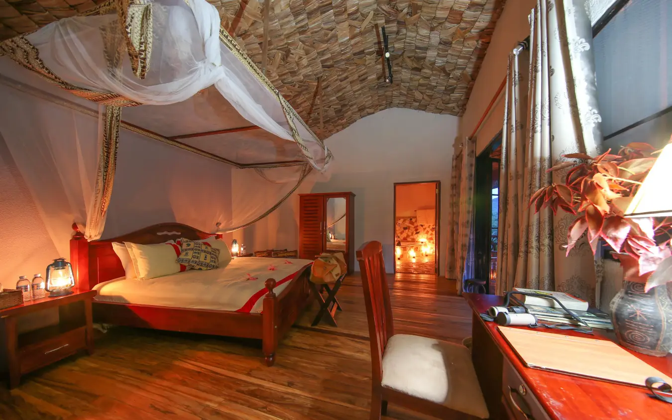 Luxury bedroom with canopy bed and warm lighting, Mahogany Springs, Bwindi Impenetrable Forest, Uganda