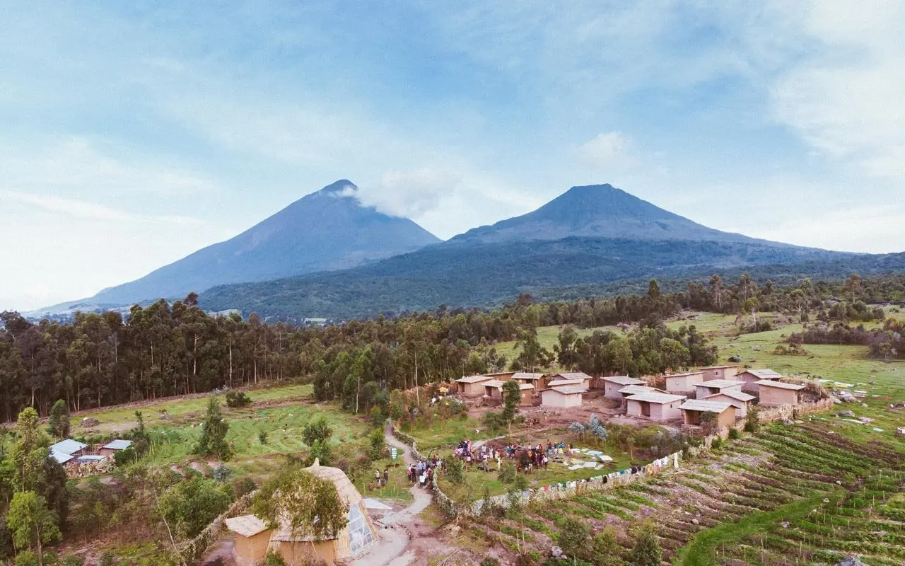 Aerial view of lodge buildings surrounded by farmland and forest, Mount Gahinga Lodge, Mgahinga National Park, Uganda