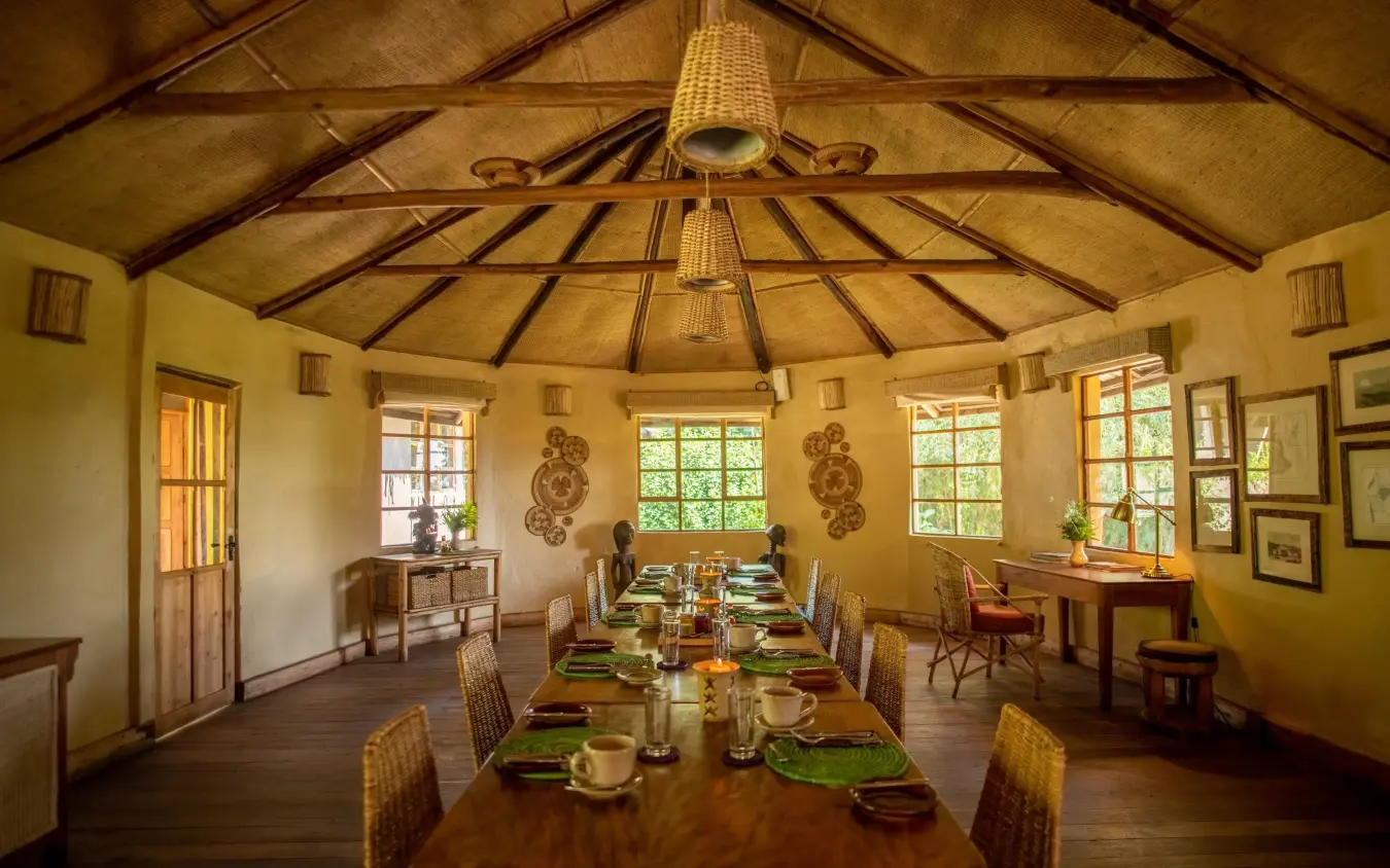 Long dining table set for meal service in lodge, Mount Gahinga Lodge, Mgahinga National Park, Uganda