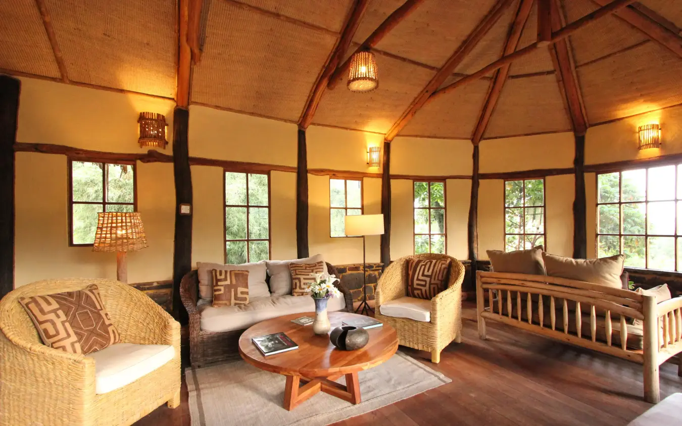 Octagonal lounge with wicker furniture and large windows, Mount Gahinga Lodge, Mgahinga National Park, Uganda