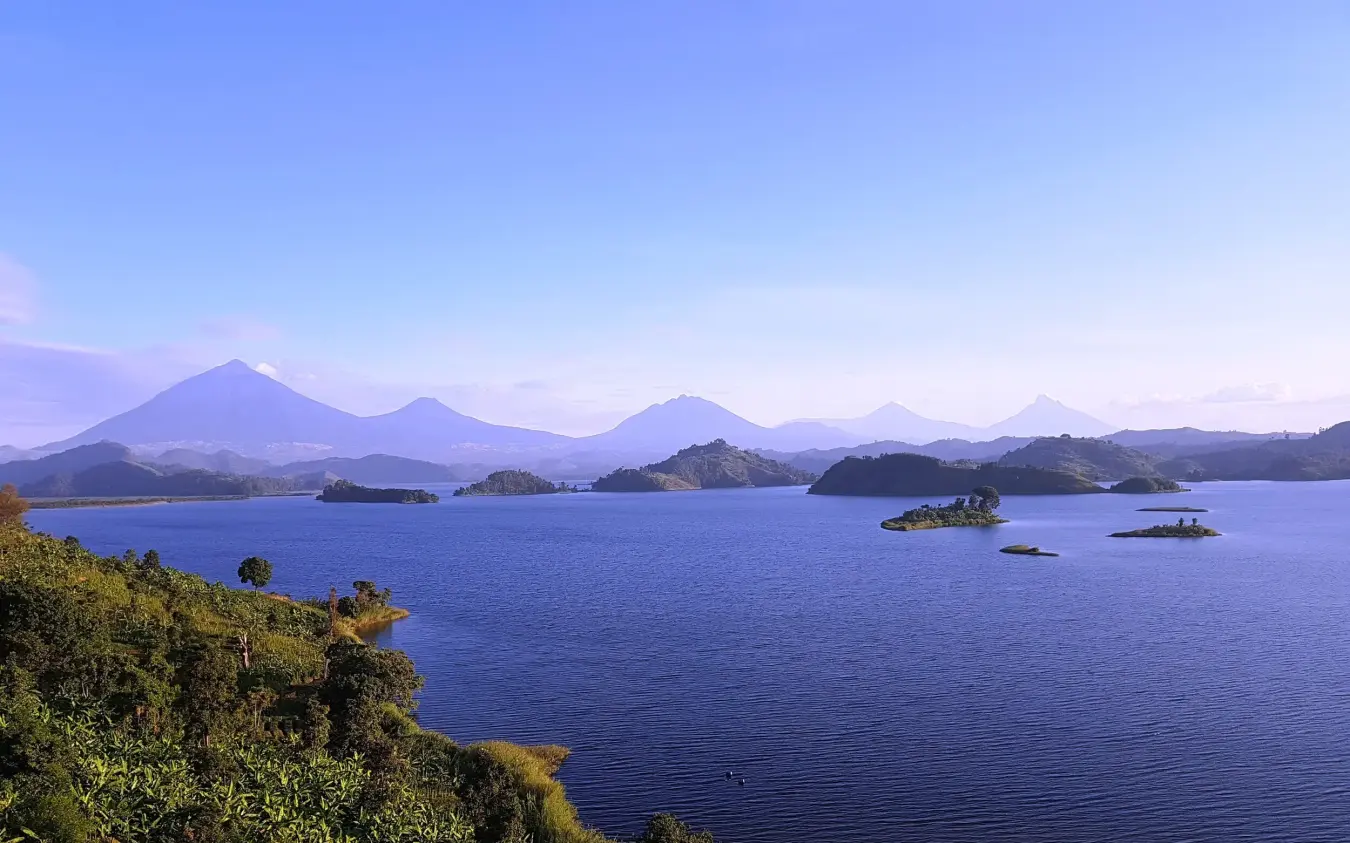 Lake with forested islands and volcanic mountains beyond, Mutanda Lake Resort, Lake Mutanda, Uganda