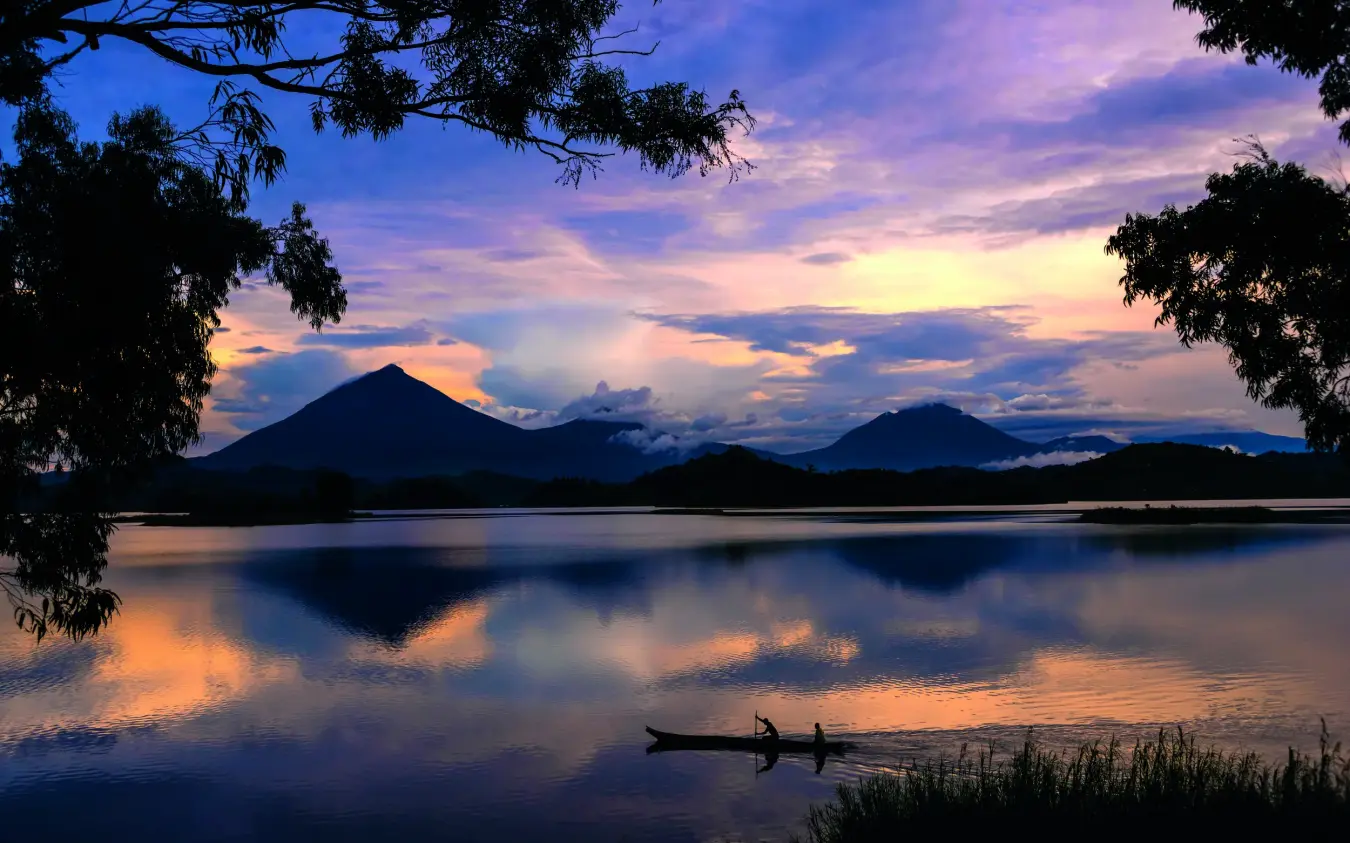 Volcanic peaks reflected in calm lake at dusk, Mutanda Lake Resort, Lake Mutanda, Uganda