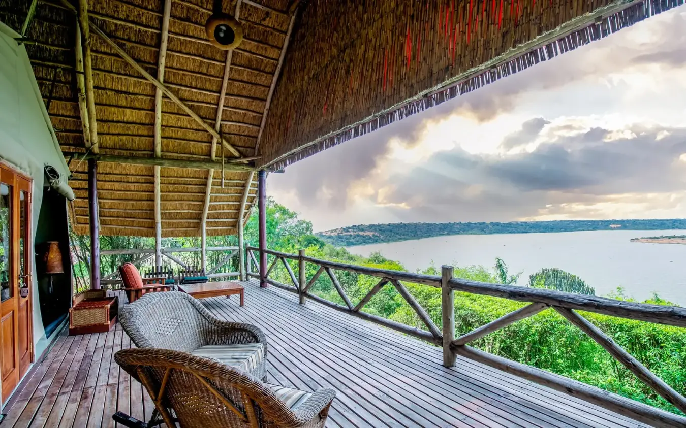 Wooden deck overlooking lake with lounge chairs and vegetation, Mweya Safari Lodge, Queen Elizabeth NP, Uganda